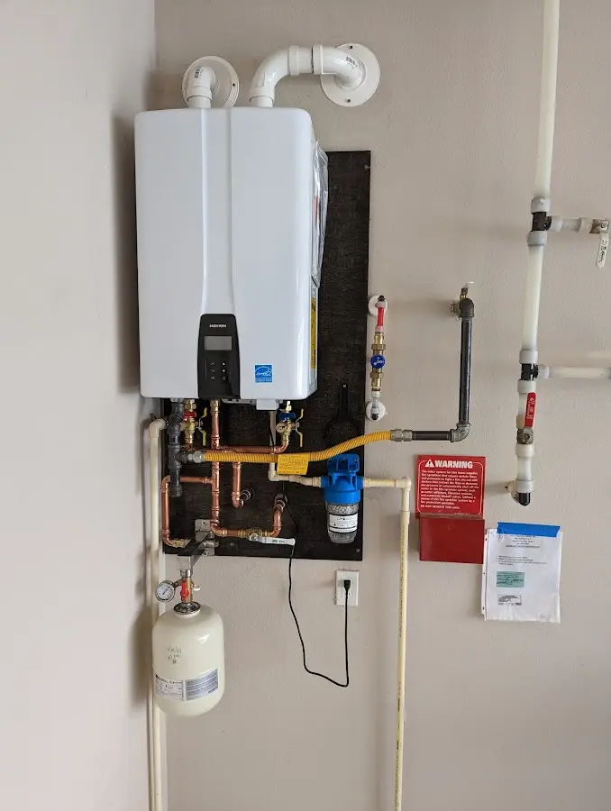 Professional plumber installing copper piping in a Riverton home